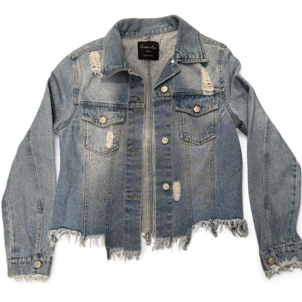 Distressed denim jacket with frayed hem and cuffs